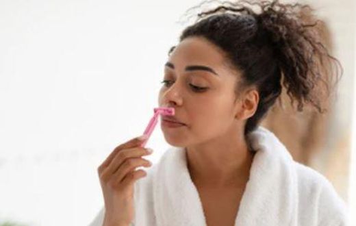 Lady shaving her face