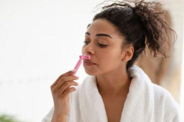 Lady shaving her face