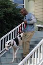 Man Walking His Pet Dog Down the Stairs