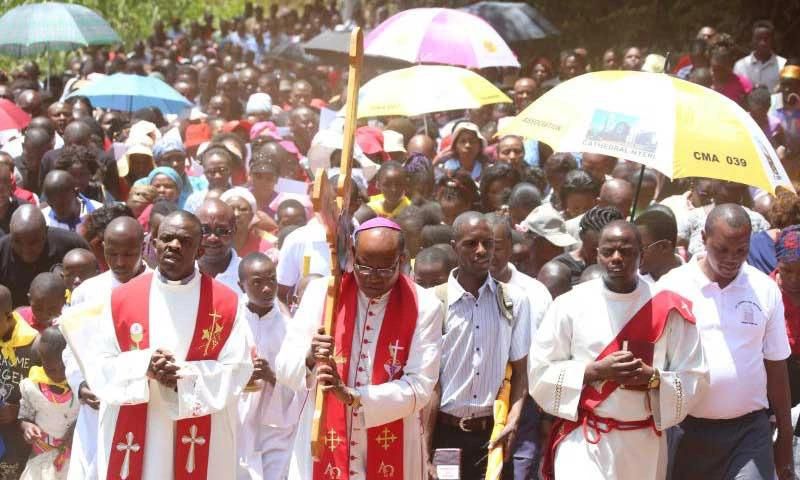 Nyeri Catholic Archbishop Antony Muheria carries a cross as led other faithful in a religious procession to Our Lady of Constanta Cathedral in Nyeri during a past event