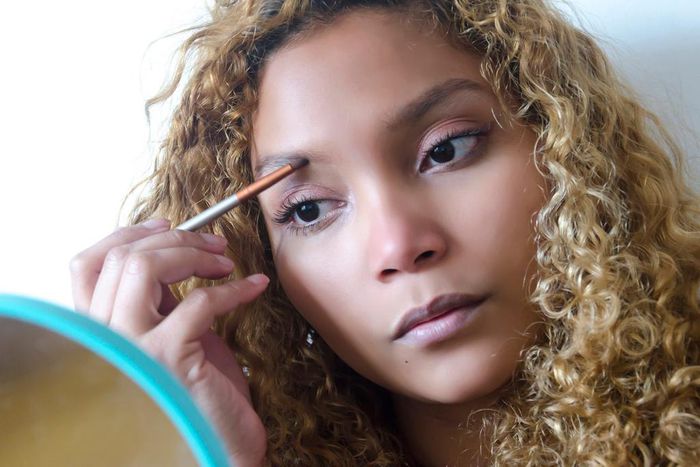 A stock image of a woman doing her eyebrows.Elizabeth Fernandez/Getty Images