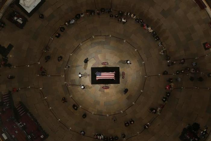Tens of thousands of Americans have quietly filed in to pay their respects to George H.W. Bush, a man who steered the nation through turbulent times including the end of the Cold War