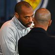 Thierry Henry speaks with Belgium coach Roberto Martinez