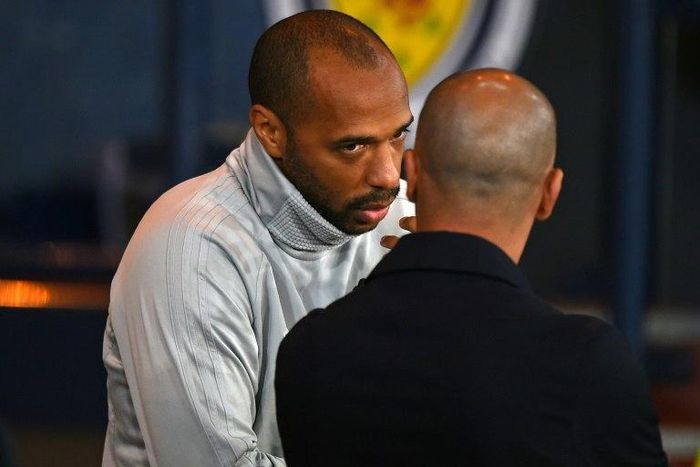 Thierry Henry speaks with Belgium coach Roberto Martinez