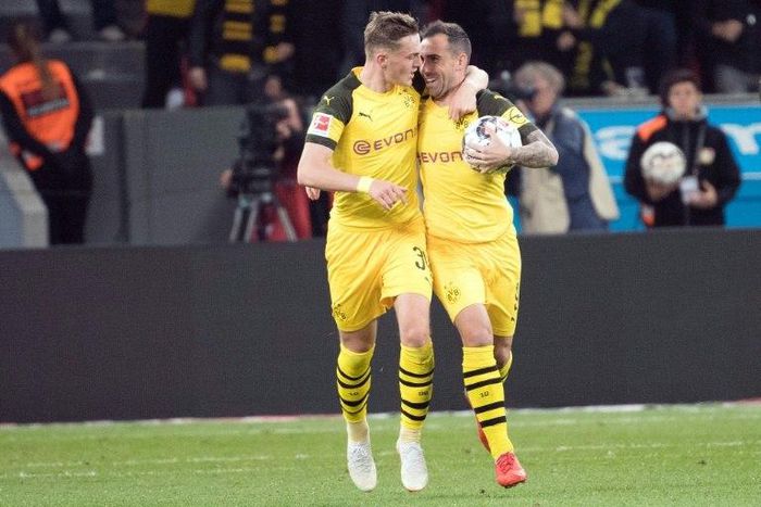 Match-winner Paco Alcacer (R) is congratulated by Danish forward Jacob Bruun Larsen (L) as Borussia Dortmund came back from two goals down to win 3-2 at Bayer Leverkusen on Saturday and knock Bayern Munich from top spot in the Bundesliga.