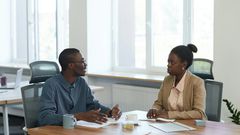 Man and woman having a conversation at the office [Image Credit: Edmond Dantès]