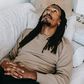 Pensive black man lying on couch [Photo: Alex Green]