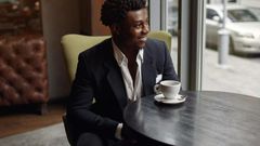 Black man sitting in a cafe [Nohat]