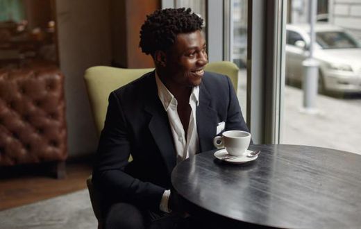 Black man sitting in a cafe [Nohat]