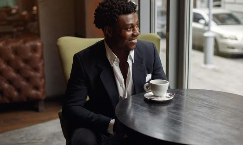 Black man sitting in a cafe [Nohat]