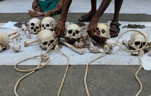 An Indian farmer from Tamil Nadu state arranges human skulls, said to belong to farmers who had committed suicide, during a protest in New Delhi on August 1, 2017