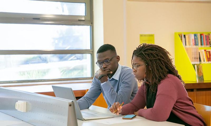 Students preparing a presentation for studies in a classroom [Image: Kampus Production]