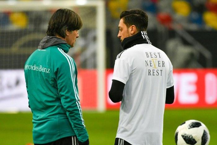 Germany head coach Joachim Loew (L) talks to midfielder Mesut Ozil during a training session last March. Ozil quit international duty in July, citing racism and disrespect within the German FA (DFB) and has reportedly broken contact with Loew.