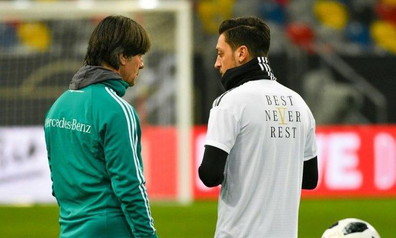 Germany head coach Joachim Loew (L) talks to midfielder Mesut Ozil during a training session last March. Ozil quit international duty in July, citing racism and disrespect within the German FA (DFB) and has reportedly broken contact with Loew.