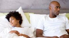 Unhappy couple in bed