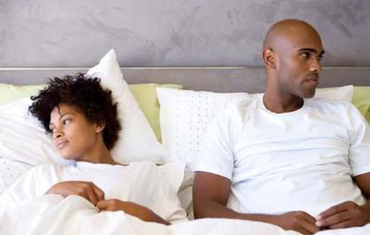 Unhappy couple in bed