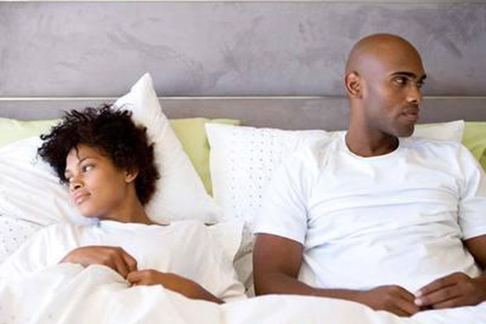 Unhappy couple in bed