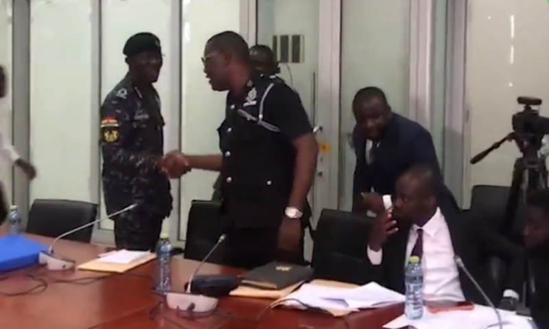 IGP Dampare exchanges pleasantries in a handshake with Supt. Asare wants him removed