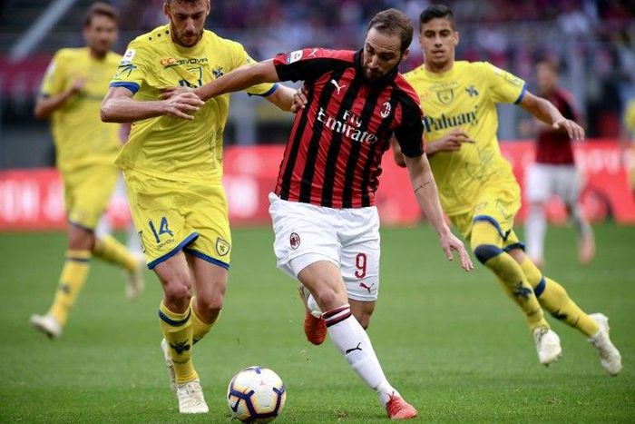 Chievo defender Mattia Bani struggles to contain AC Milan's Gonzalo Higuain in last weekend's defeat for the Verona club
