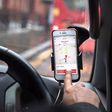A driver uses the Uber Technologies Inc. ride-hailing service smartphone app to complete passenger drop-off in this arranged photograph in London, U.K., on Friday, Dec. 22, 2017. Uber will be regulated in European Union countries as a transport company...