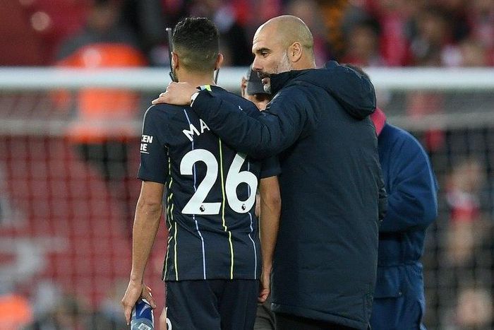 Manchester City manager Pep Guardiola consoles Riyad Mahrez after his missed penalty against Liverpool
