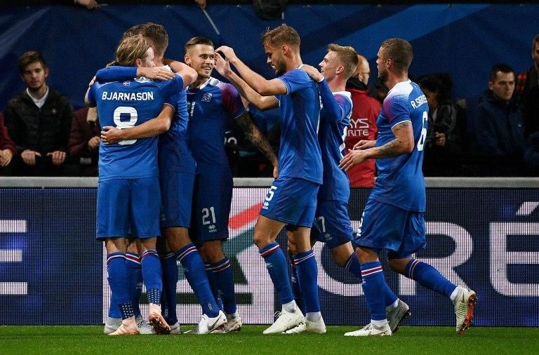 Kari Arnason (C) is mobbed by his teammates after heading Iceland into a 2-0 lead