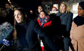 Rep.-elect Alexandria Ocasio-Cortez speaks at a Tuesday rally outside an orientation meeting for incoming members of Congress at Harvard as Rep.-elect Ayanna Pressley, D-Mass., right, and Rep.-elect Lori Trahan, D-Mass., second from right, look on.