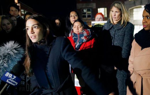 Rep.-elect Alexandria Ocasio-Cortez speaks at a Tuesday rally outside an orientation meeting for incoming members of Congress at Harvard as Rep.-elect Ayanna Pressley, D-Mass., right, and Rep.-elect Lori Trahan, D-Mass., second from right, look on.