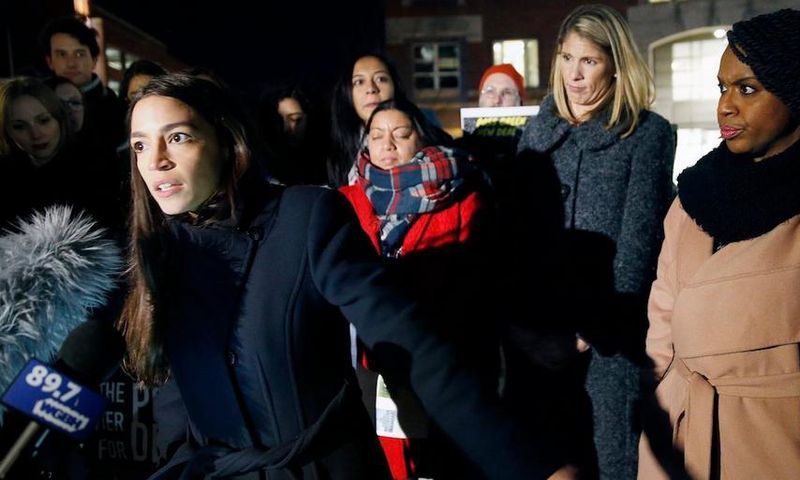Rep.-elect Alexandria Ocasio-Cortez speaks at a Tuesday rally outside an orientation meeting for incoming members of Congress at Harvard as Rep.-elect Ayanna Pressley, D-Mass., right, and Rep.-elect Lori Trahan, D-Mass., second from right, look on.