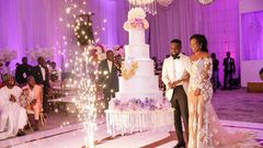 Sarkodie and Tracy cutting their huge white wedding cake