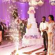 Sarkodie and Tracy cutting their huge white wedding cake