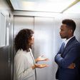 Black couple inside an elevator [Adobe Stock]