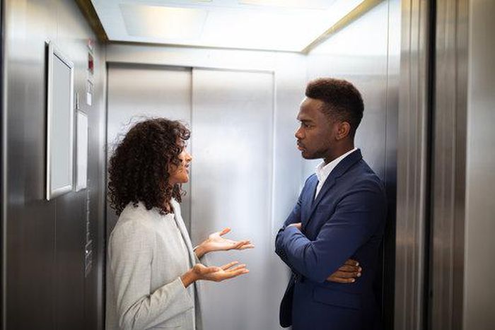 Black couple inside an elevator [Adobe Stock]