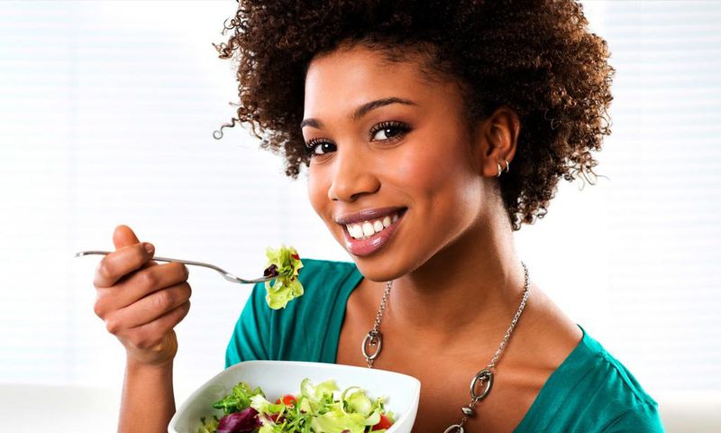 Woman eating vegetables(ebony)