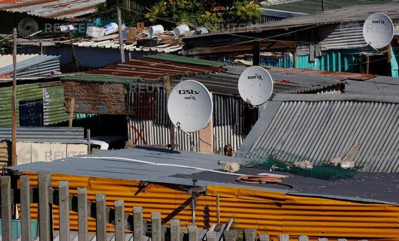 Satellite dishes connect township residents to South Africa's DSTV television network, owned by telecommunications giant Naspers, in Khayelitsha township, Cape Town, May 19, 2017.