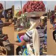 Fruit seller carrying a tray of fruits while riding motorcycle sparks reactions