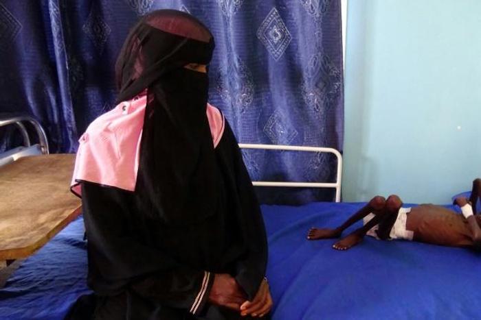 This picture taken on November 22 shows Yemeni mother Nadia Nahari sitting next to her five-year-old son who is suffering from severe malnutrition and weighing 5 kilogrammes. The UN says it will need to provide food assitance to 12 million people next ...