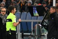 Referee Gianluca Rocchi checks the Video assistant referee during the Italian Serie A football match between AS Roma and Lazio on November 18, 2017 at the Olympic stadium in Rome
