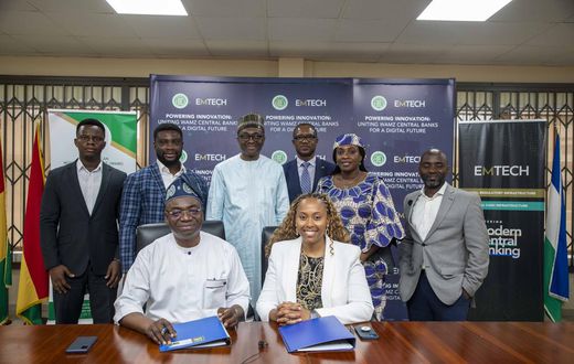 Leadership of WAMI and EMTECH in a group photograph after the signing ceremony