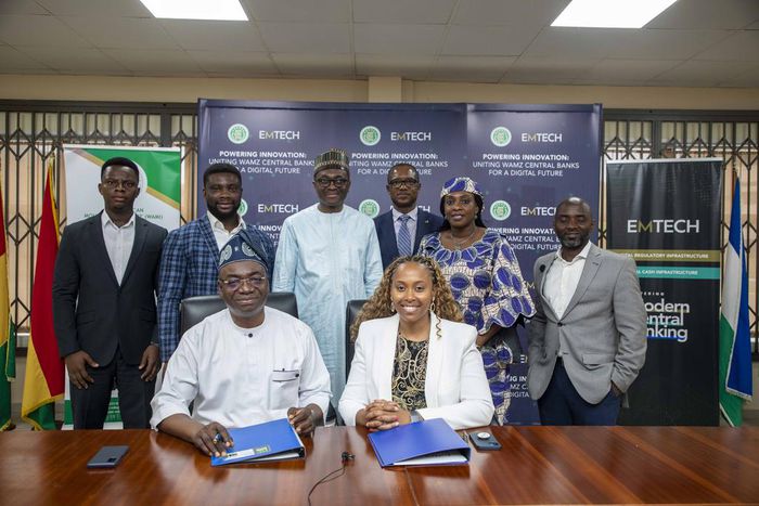 Leadership of WAMI and EMTECH in a group photograph after the signing ceremony