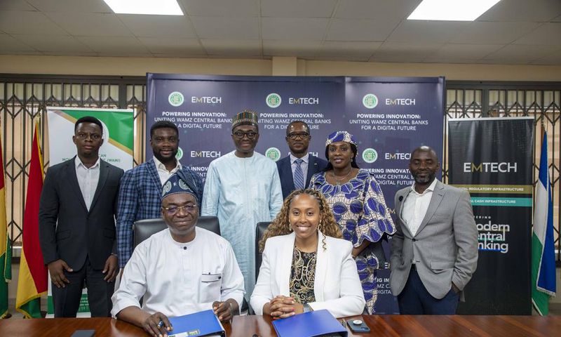 Leadership of WAMI and EMTECH in a group photograph after the signing ceremony