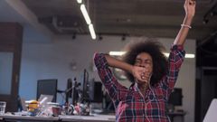 woman yawning at work tired