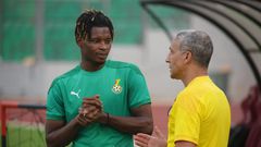 Chris Hughton speaking to midfielder Edmund Addo