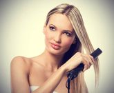 Woman using hair straightener