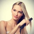 Woman using hair straightener