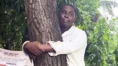 Abdul Hakim Awal hugs tree for 24 hours to break world record and promote reforestation