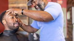 A man getting a haircut in a barbershop