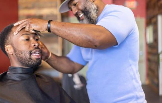 A man getting a haircut in a barbershop