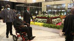Ex-President John Agyekum Kufuor filing past the remains of the late former President Jerry John Rawlings in January, 2021, while sitting in a wheelchair