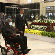 Ex-President John Agyekum Kufuor filing past the remains of the late former President Jerry John Rawlings in January, 2021, while sitting in a wheelchair